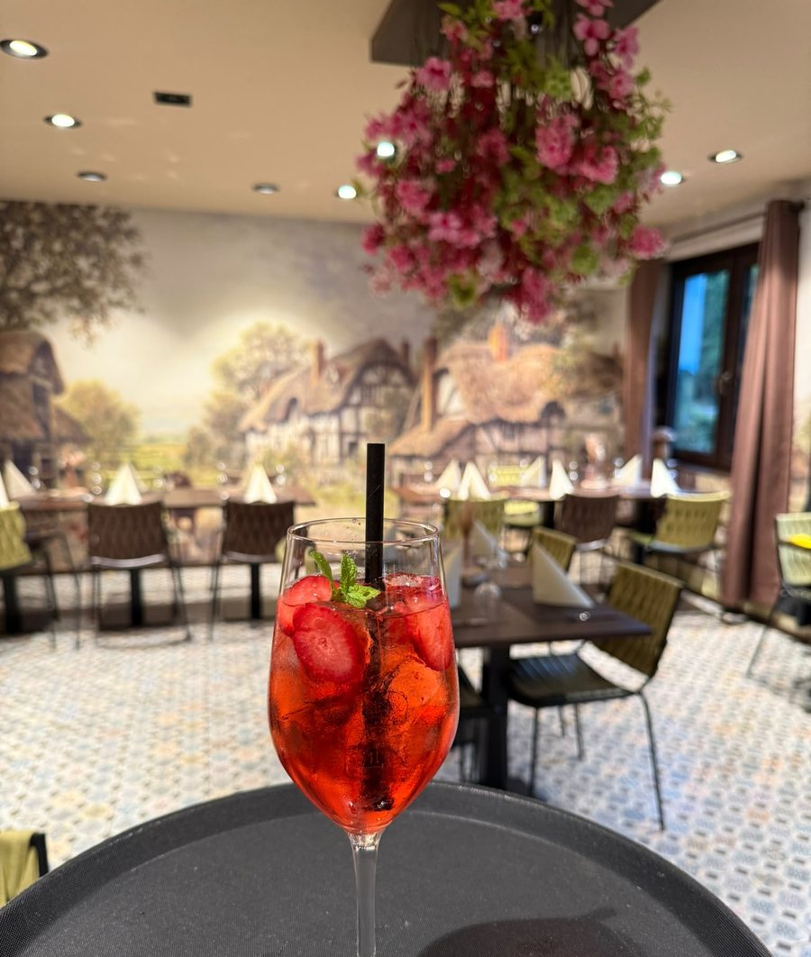 Gabi’s Spritz im Weinglas unter der Blütenampel